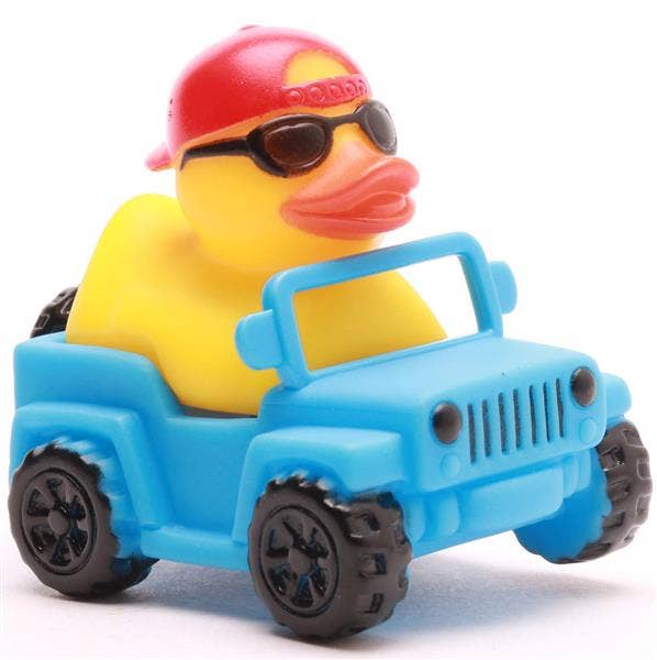 Mini pato de goma en Jeep azul desde un ángulo lateral