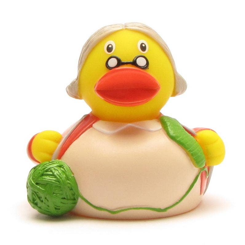 Pato de goma abuela con gafas y agujas de punto visto de frente